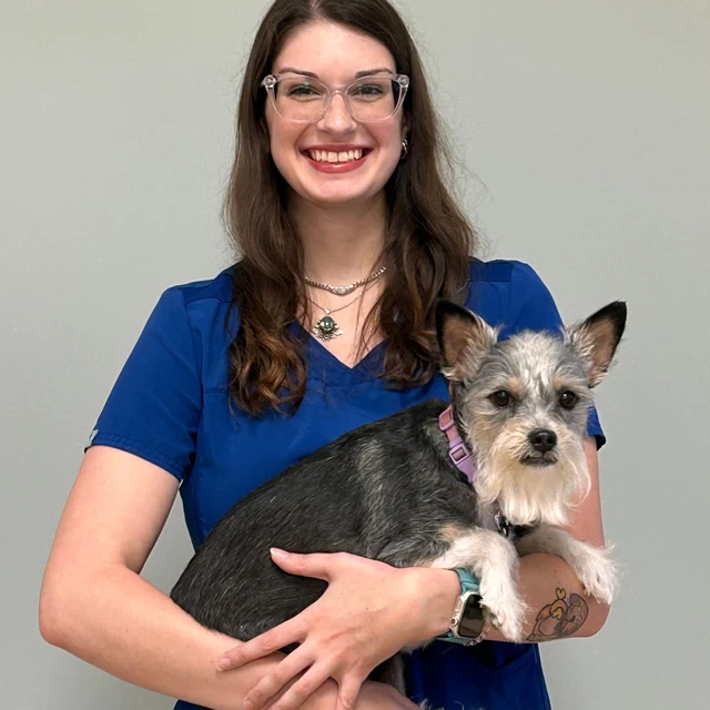 Grace Luczak of South Town Animal Hospital, holding a small terrier