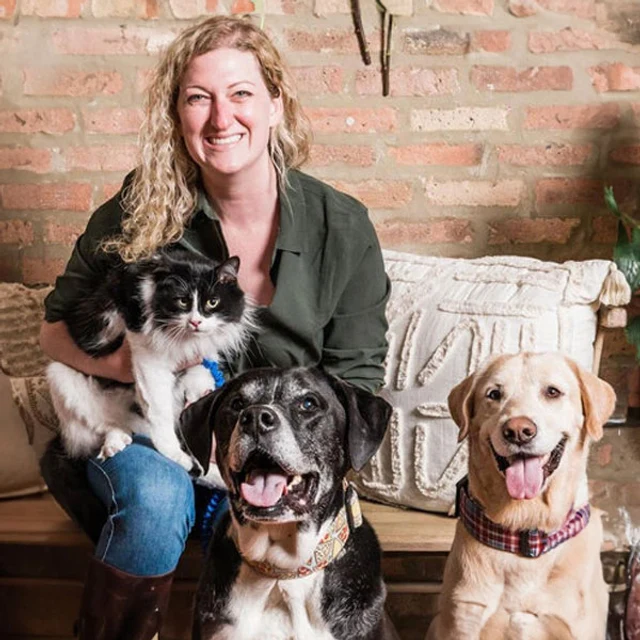 Dr. Jacquie Cobb, DVM, owner of South Town Animal Hospital, with her cat and two dogs